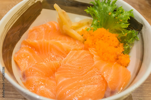 Raw salmon on cooked rice photo