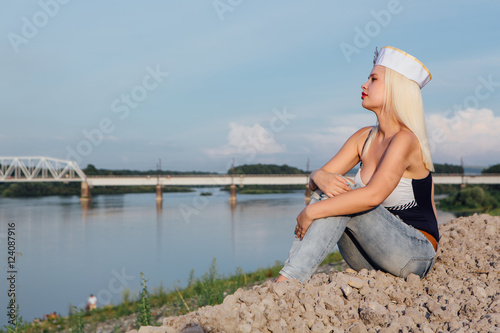 Young girl on the river shore