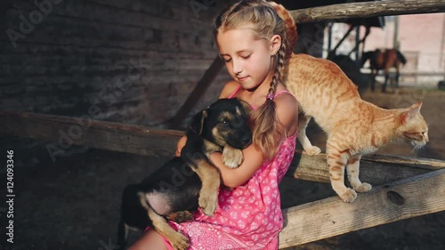 Curly Girl Caresses a Puppy and Cat at the Farm