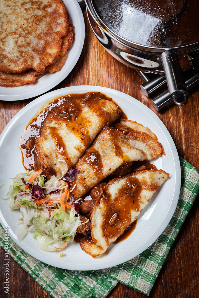Potato pancakes with meat stew served Potato pancakes with meat stew served