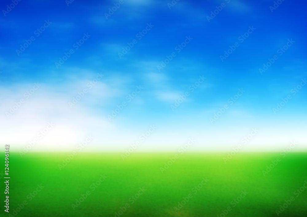 blurred meadow with blue sky background