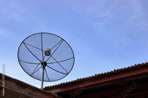 Satellite dish on the roof , blue sky background.