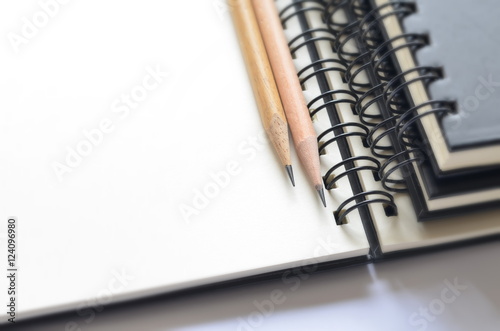 Selective focus of wooden pencils on blank sketched book with copy space for writing your new idea