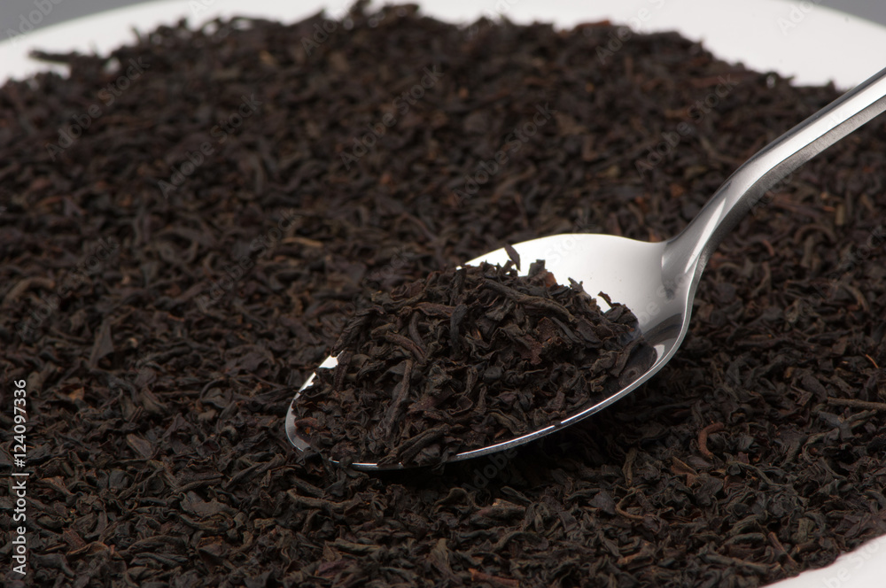 one spoon with black tea leaves close-up one spoon with black tea leaves close-up