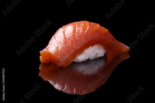 Sushi salmon over black background