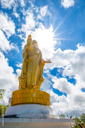 Big standing buddha statue with sun