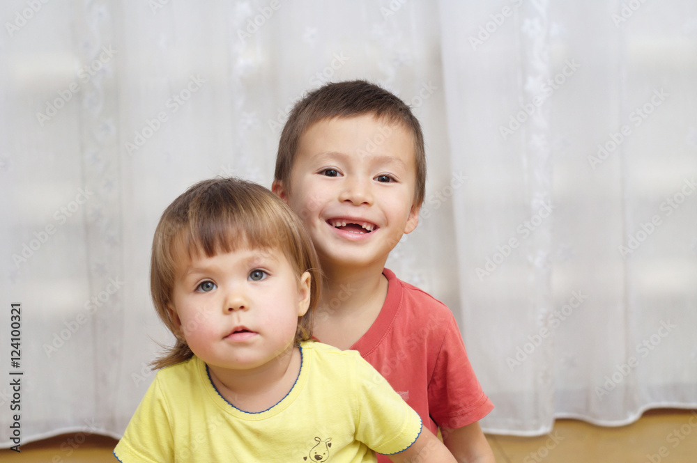 Sibling sitting together indoor Sibling sitting together indoor