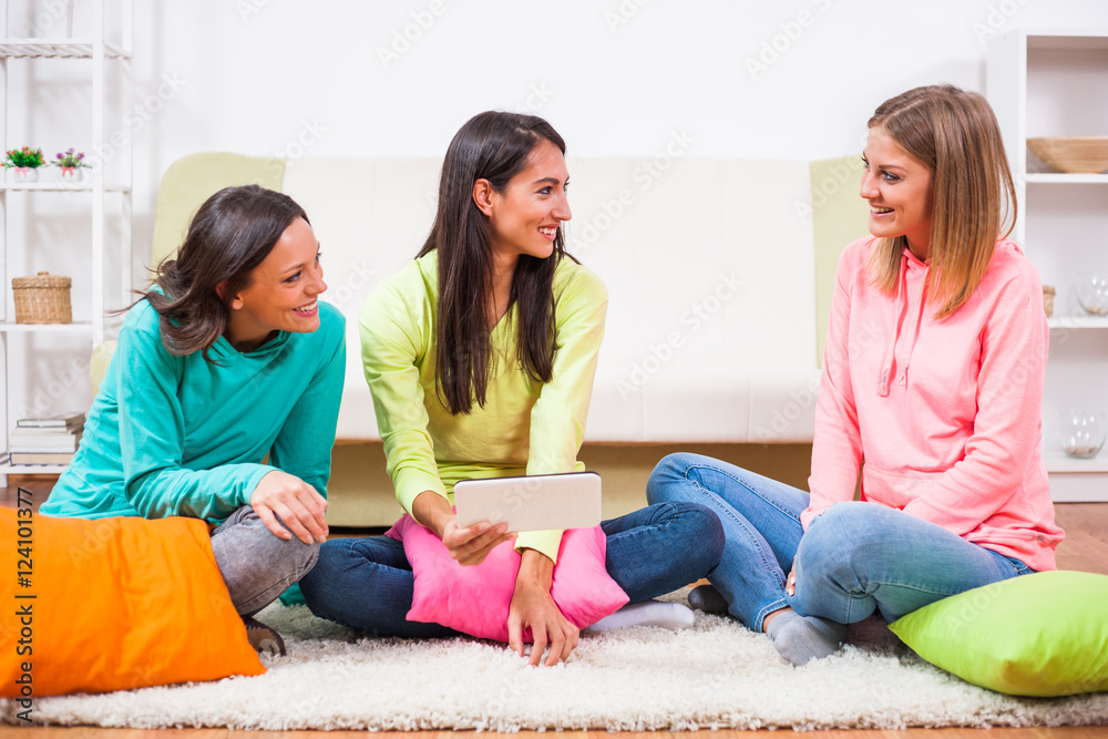 Three friends are sitting in room and using digital tablet. Three friends are sitting in room and using digital tablet.
