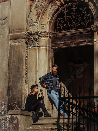 fashionable couple near old building