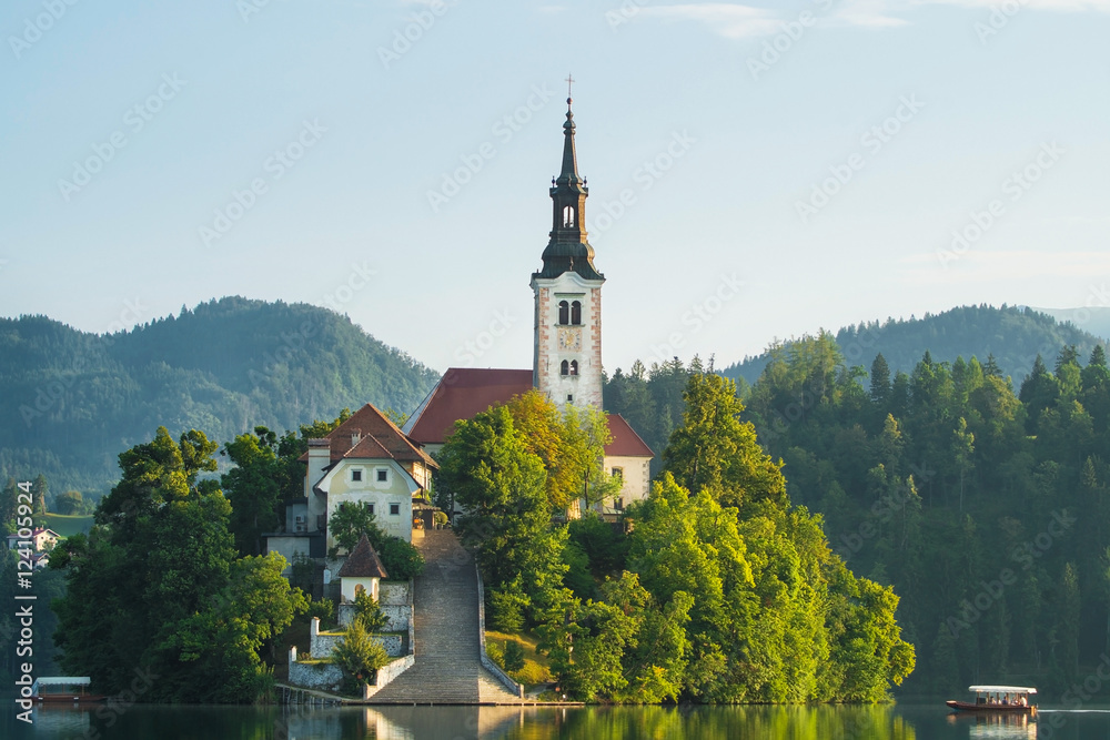 Bled island closeup with boat and pletna on Lake Bled in Sloveni