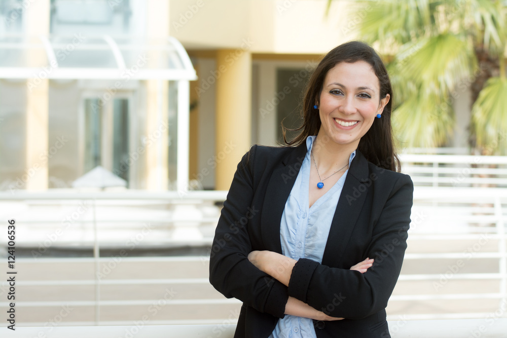 Successful business woman looking confident and smiling, outside Successful business woman looking confident and smiling, outside