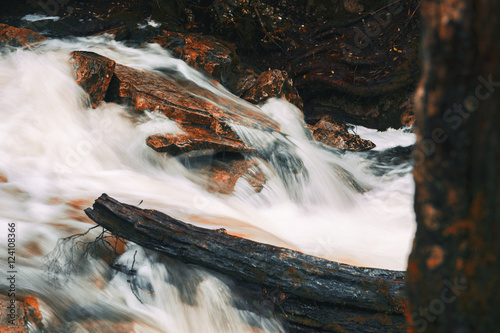 Knyvet Falls in Cradle Mountain, Tasmania after heavy rainfall with abstract red hues added.