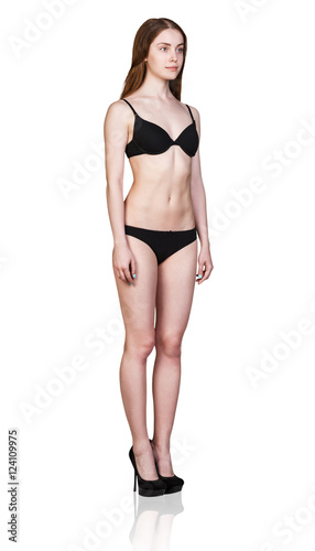 Young woman stands in black lingerie
