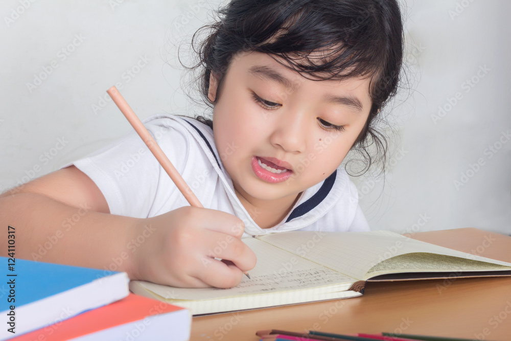 Beautiful little girl looking focused and concentrated on doing Beautiful little girl looking focused and concentrated on doing