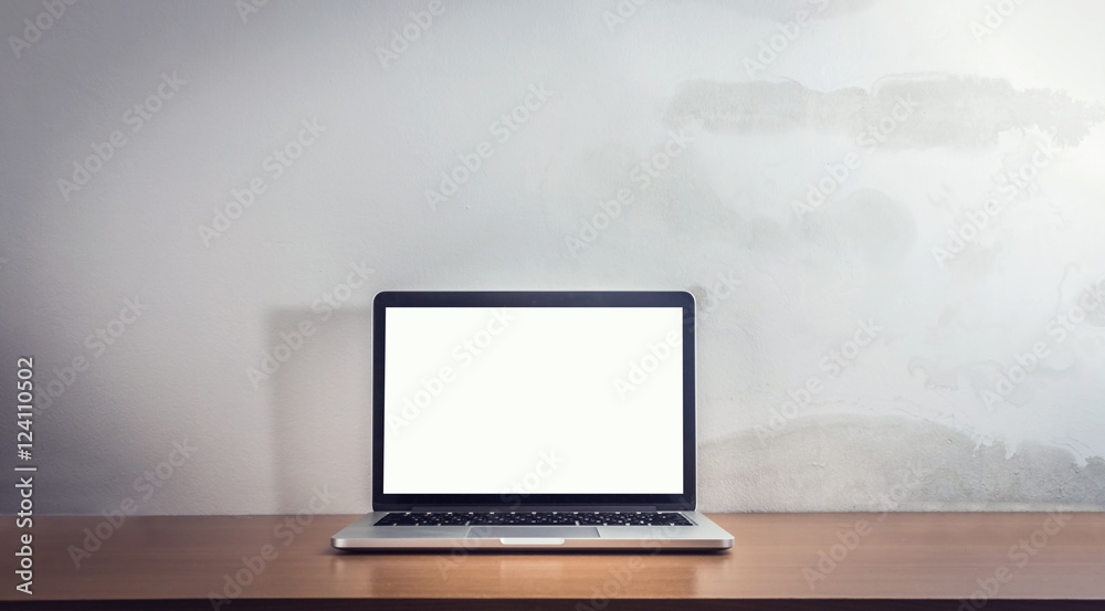 Front view of the laptop is on the work table, concrete backgrou Front view of the laptop is on the work table, concrete backgrou