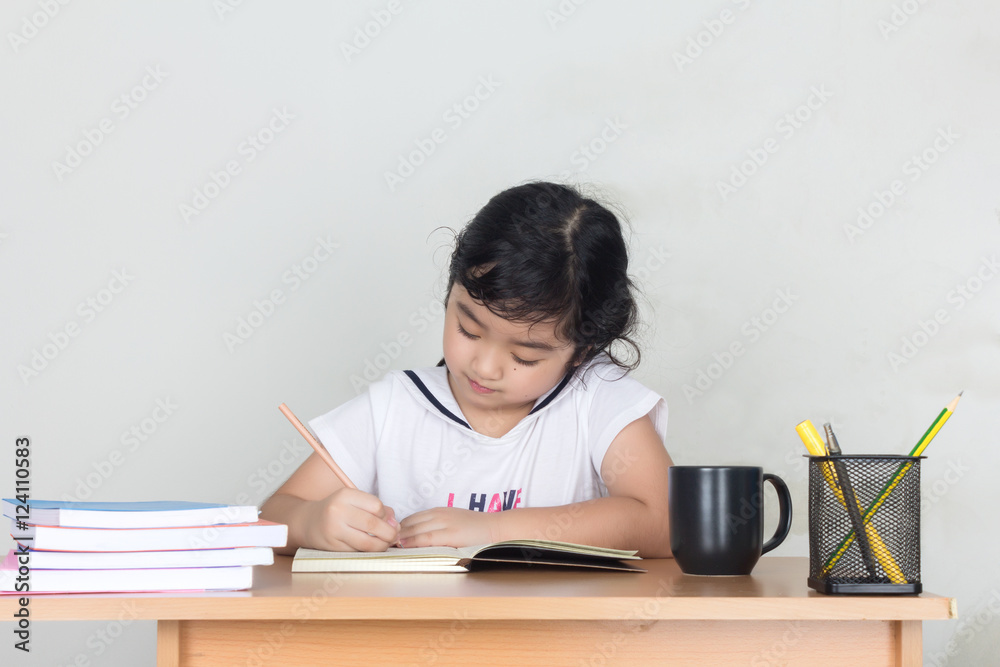 Beautiful little girl looking focused and concentrated on doing Beautiful little girl looking focused and concentrated on doing