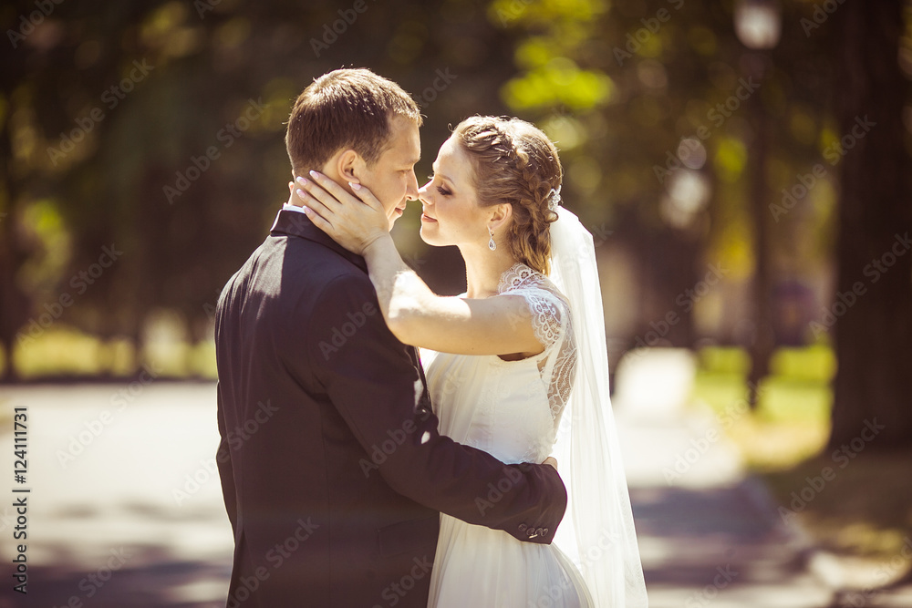charming bride kisses and hugs her husband