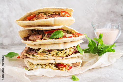Meat pita bread with yogurt sauce and mint leaves