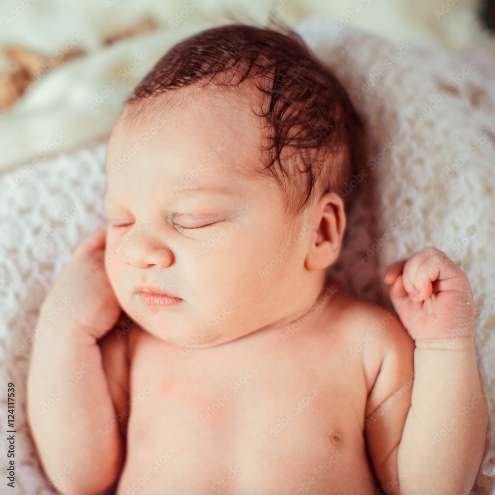 Incredible and sweet newborn baby sleeps on the bed Incredible and sweet newborn baby sleeps on the bed