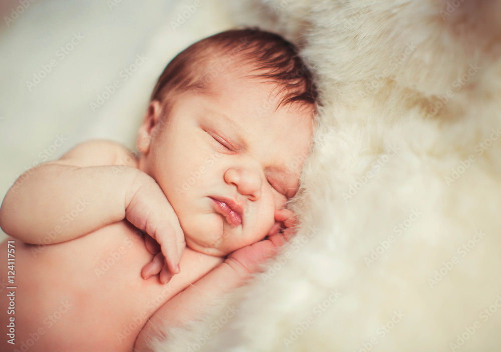 Incredible and sweet newborn baby sleeps on the bed Incredible and sweet newborn baby sleeps on the bed