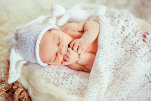 Картината върху платно Incredible and sweet newborn baby sleeps in basket