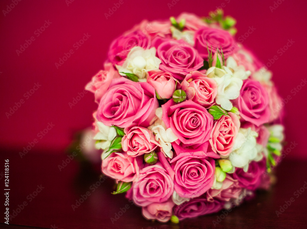 A closeup of wedding bouquet lying on the red table
