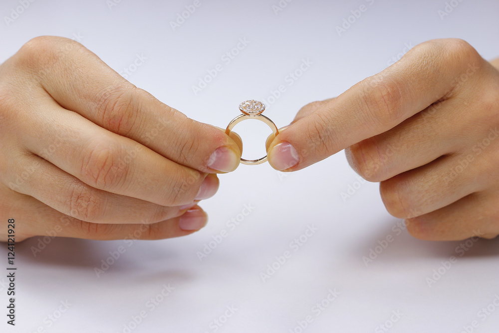 Hands holding a ring on a white background Hands holding a ring on a white background
