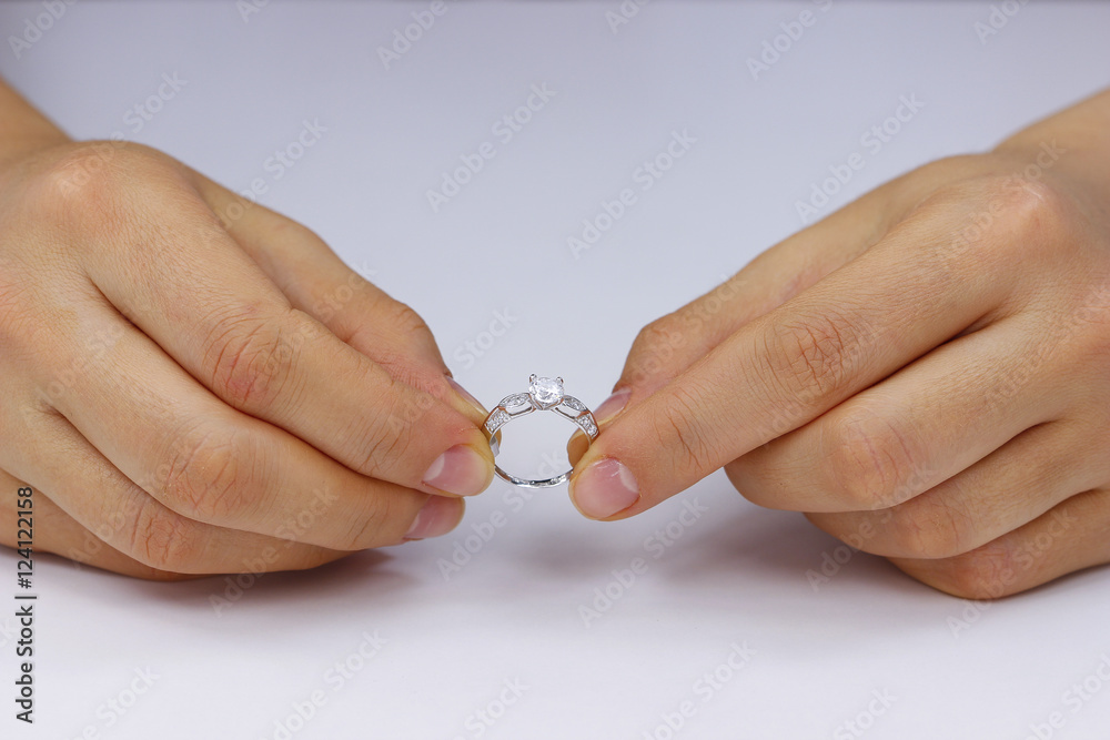 Hands holding a ring on a white background Hands holding a ring on a white background