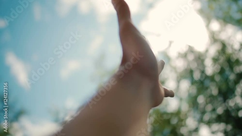 Hand of man reaching for the sun photo