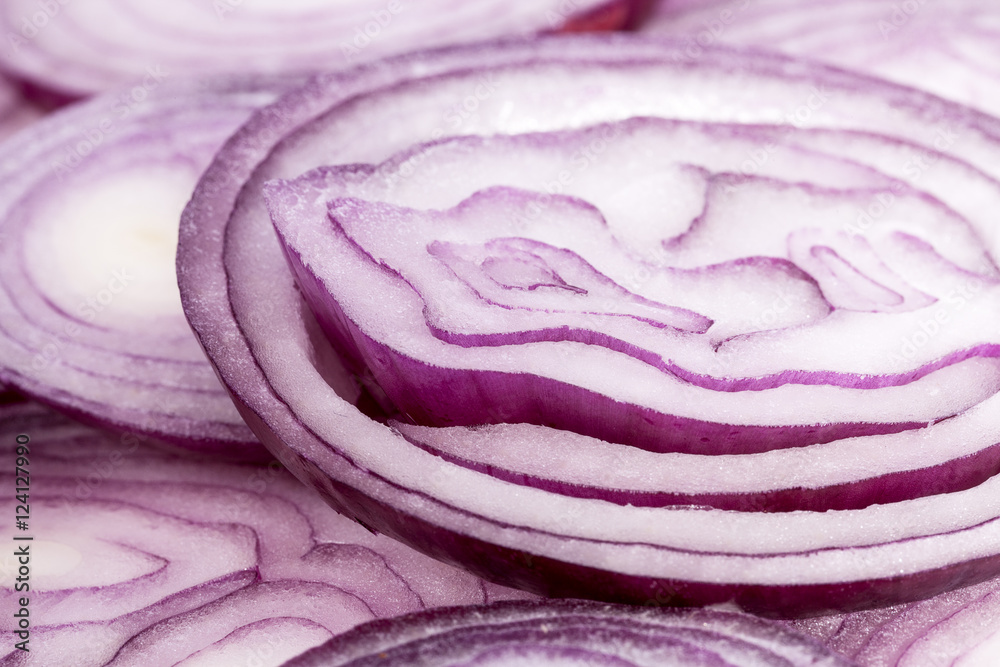 Fototapeta premium Slices of red onion on white background, close up