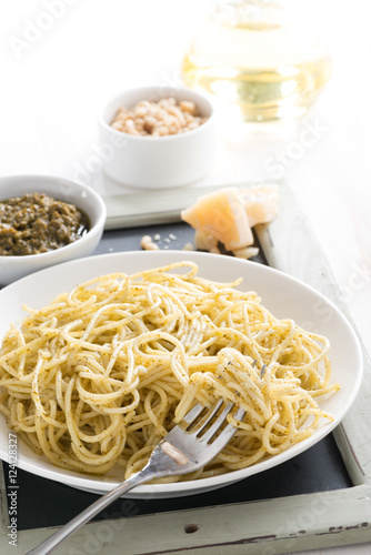 spaghetti with pesto and cheese, vertical