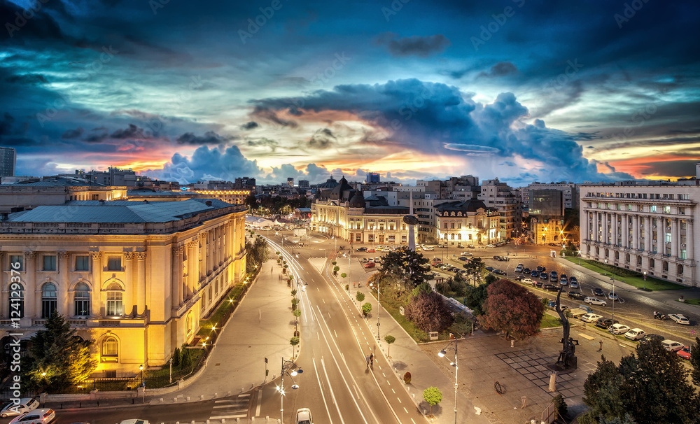 Long exposure shot of the Revolution Square near Victoria Avenue in Bucharest, Romania. Traffic and historical buildings.Bucuresti