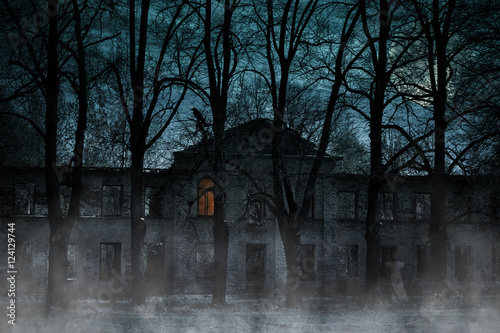 Old house with a Ghost in the moonlit night