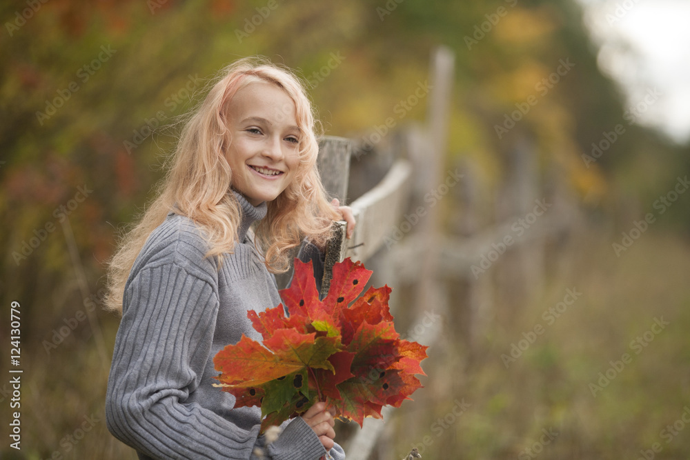 The little girl in the autumn forest The little girl in the autumn forest