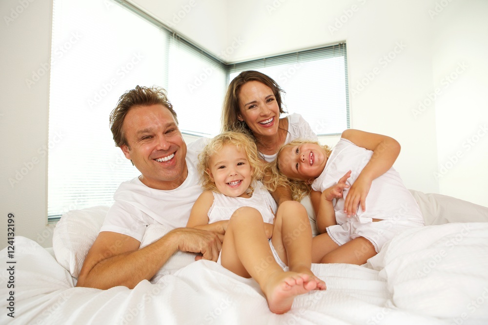 Happy family on bed in the bedroom