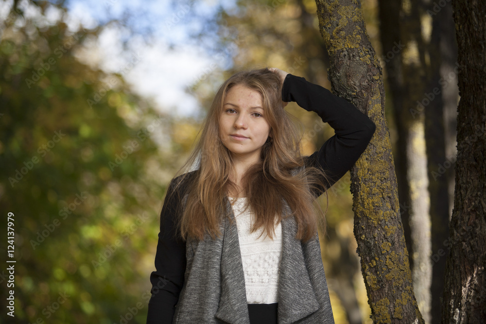 Girl with a cute smile on sunny autumn day Girl with a cute smile on sunny autumn day