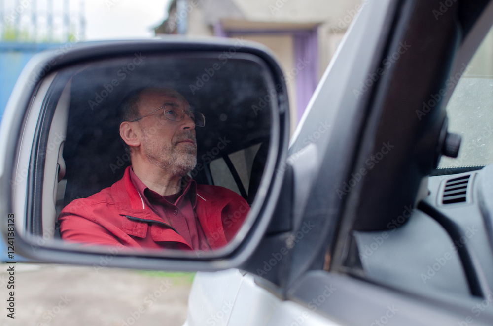 Aged man in the car