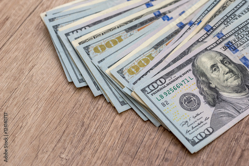 american dollar bills on wooden desk