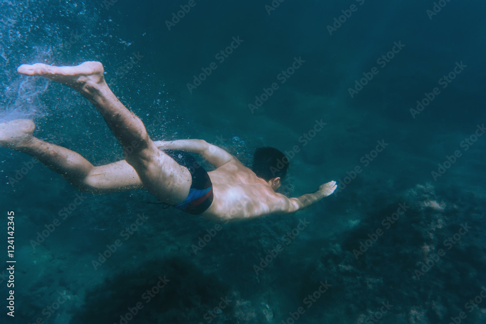Man snorkeling in deep sea