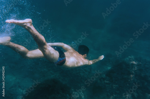 Man snorkeling in deep sea