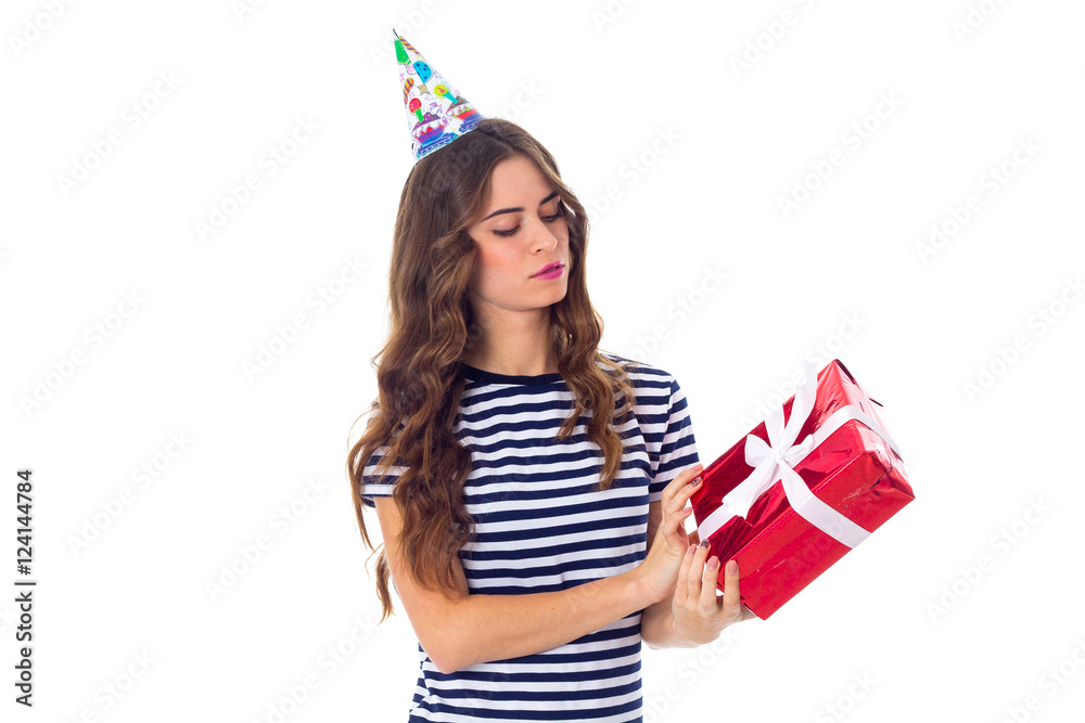 Woman in celebration cap holding a present Woman in celebration cap holding a present