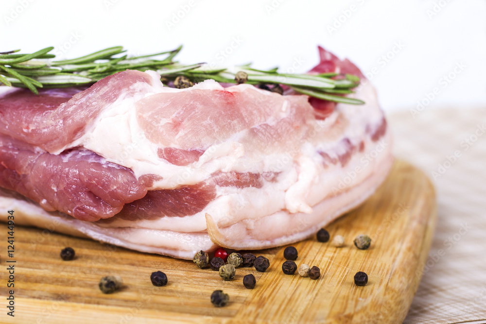 Fresh meat : raw pork  with pepper sweet pea and rosemary on wooden board