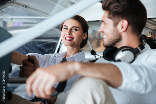 Couple sitting in cabine of small airplane