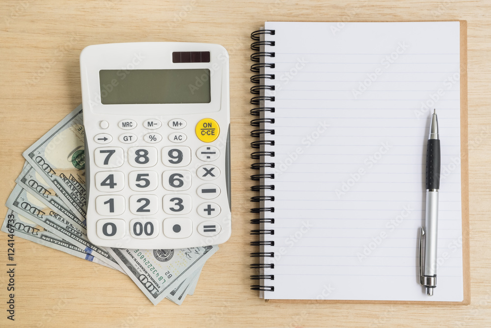 Top view of notebook calculator cash Top view of notebook calculator cash