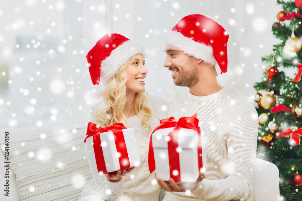happy couple at home exchanging christmas gifts happy couple at home exchanging christmas gifts