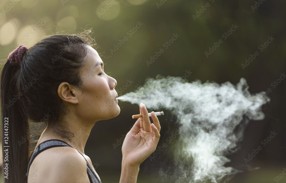 Woman Smoking a Cigarette Stock Photo | Adobe Stock