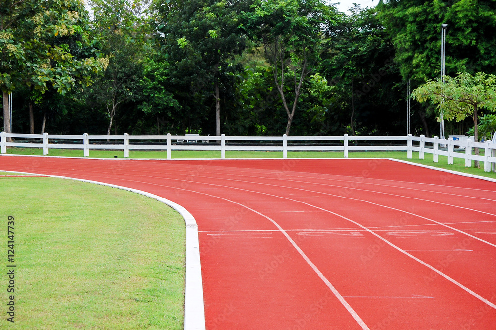 Fototapeta premium Running track and sports-field in green natural surrounding.