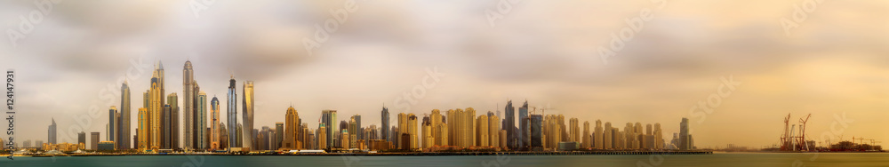 Panoramic view of Dubai Marina bay with cloudy sky, Dubai, UAE.