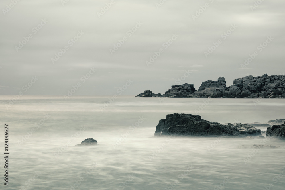 Long exposure shot of rocky beach in Cornwall, England