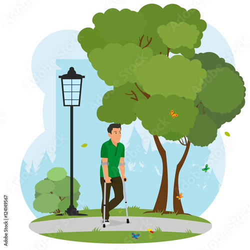 man on crutches walking in the park on nature.